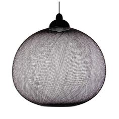 a black and white photo of a round light fixture hanging from a corded wire