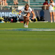 a woman is playing field hockey on the field