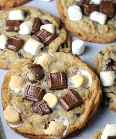 chocolate chip cookies with marshmallows and chocolate chips on top are ready to be eaten