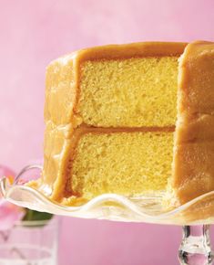 a slice of yellow cake sitting on top of a glass plate