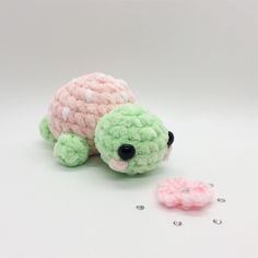 there is a small stuffed turtle next to some beads