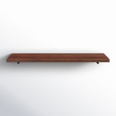 a wooden shelf mounted on the wall