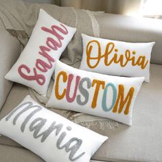 three personalized pillows on a couch