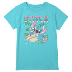 Dive into the world of adventure with the Lilo & Stitch Girls' Surfing Stitch T-Shirt! This vibrant blue tee is a must-have for any young fan of the beloved Disney movie.

- Size: X Large Plus
- Color: Blue
- Material: Cotton blend
- Gender: Female
- Age Group: Kids

Featuring a dynamic graphic of Stitch surfing under a moonlit sky, surrounded by palm trees and tropical flowers, this shirt captures the essence of the islands with the cheerful greeting "Aloha" above. Perfect for everyday wear, th Character Style Cotton Short Sleeve Tops, Blue Short Sleeve Themed Tops, Disney Blue Pre-shrunk Tops, Disney Blue Summer Tops, Blue Disney Cartoon Print T-shirt, Playful Blue Relaxed Fit T-shirt, Stitch Surfing, Girls Surfing, Tropical Backdrop