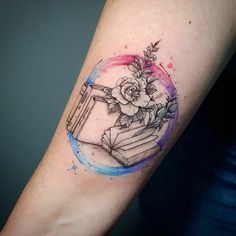 a tattoo on the arm of a woman with books and flowers