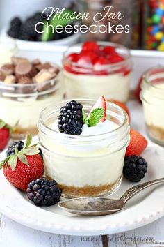 mason jar cheesecakes with fresh berries and chocolate chips in the background on a white plate