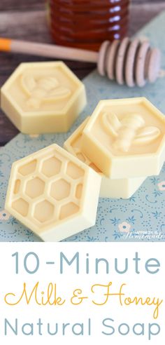 two wax blocks sitting on top of a wooden table next to a jar of honey