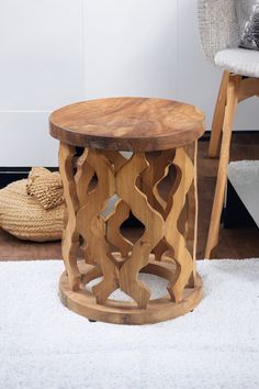 a wooden stool sitting on top of a white rug