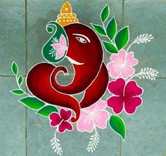 an elephant is painted on the ground with flowers and leaves around its neck, as if it's for ganeshi