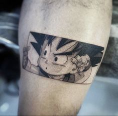 a man's leg with a cartoon character tattoo on the side of his leg