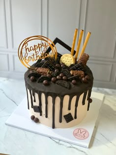 a birthday cake decorated with chocolate and cookies