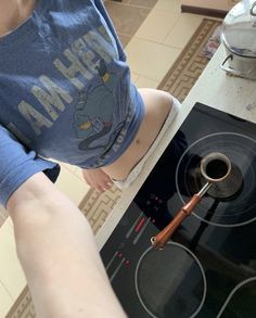 a person standing in front of a stove top