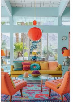 a living room filled with furniture and lots of bright colored pillows on top of it