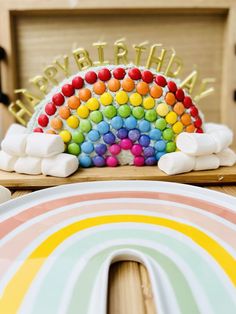 there is a rainbow cake on the table