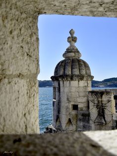 the view from inside an old building looking out at water