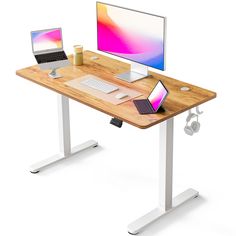 a computer desk with a laptop, monitor and keyboard on it