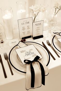 the table is set with black and white place settings