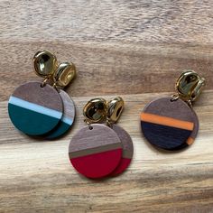 three pairs of wooden earrings with different colors