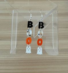 Introducing the Haunting Ghosts Collection featuring spook-tacular acrylic earrings! Make a ghostly statement with these hauntingly cute earrings. Don't wait, these boo-tiful earrings are sure to fly off the shelves (ghost pun intended)! Haunting Ghosts Dangle Earrings- Measures approximately 2.75" with metal attached White Acrylic is opaque White Fleck Acrylic is opaque Black Acrylic is opaque Orange Acrylic is opaque Iridescent Acrylic- changes color based on light reflection Slight color vari Bead Ghost Earrings, Spooky Black Drop Earrings, Halloween Acrylic Earrings, Ghost Puns, Sheet Ghost Earrings, Silver Spooky Halloween Earrings, Fall Earrings, Black Acrylics, Light Reflection