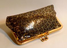 "Beautiful Leopard sequined clutch. It comes with a gold and gold frame. Lining can be changed to your custom color. Fabric: sequined fabric Lining: satin Two layers of interlining and batting Silver/nickel kisslock frame Top Width 8\" Bottom Width 9\" Height 5 1/2\" Reinforced stitching for durability *Note: A chain can be added for $4.00. Please see my chain listing. *The metal purse frame is made of iron with a nickel-free finish. It's hypoallergenic, itch and rash resistant for people with n Gold Glitter Clutch For Formal Occasions, Gold Sequin Clutch For Events, Gold Sequined Rectangular Evening Bag, Glamorous Gold Sequined Clutch, Gold Sequined Clutch Evening Bag, Gold Evening Bag With Sequins For Wedding, Gold Sequin Clutch For Parties, Gold Sequined Clutch For Party, Gold Sequined Evening Bag For Events