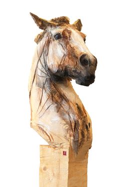 a horse head mounted on top of a wooden block in front of a white background