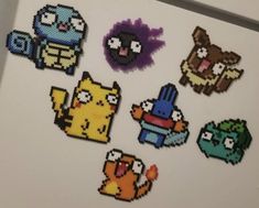 pixel art stickers are displayed on a refrigerator door in an office building, including the characters from pokemon and pikachu