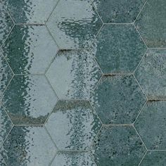 an image of a tile wall with water reflecting on the tiles and it looks like hexagonals