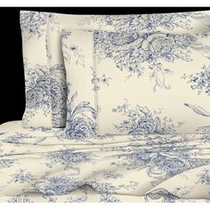 the blue and white bedding is made up with floral designs on it's sheets