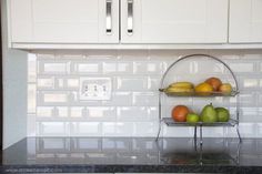 two tiered fruit trays on the kitchen counter