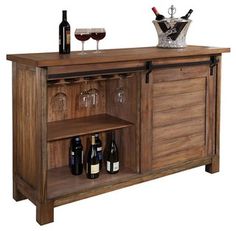 a wooden cabinet with wine glasses and bottles