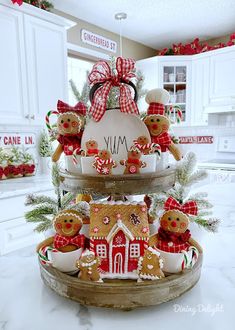 three tiered tray with gingerbread cookies and decorations