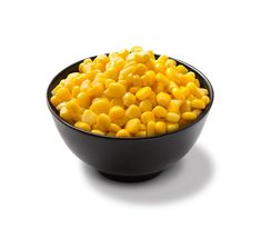 a black bowl filled with corn on top of a white table