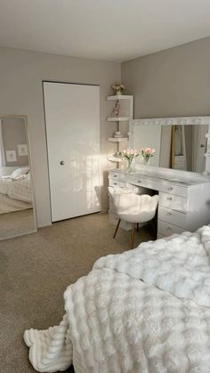 a bedroom with a bed, dresser and mirror in it's centerpieces