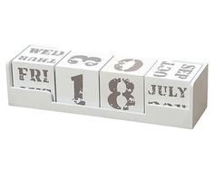 a white wooden block calendar with the numbers thirteen and eight on it's sides