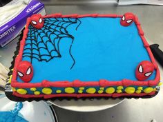 a birthday cake with spiderman decorations on it