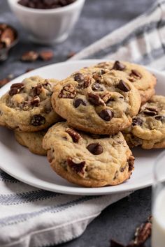 chocolate chip cookies on a plate with milk