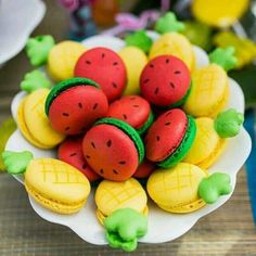 there is a plate that has some fruit on it, and two are in the shape of macaroons