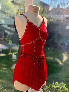 a mannequin wearing a red dress with sequins