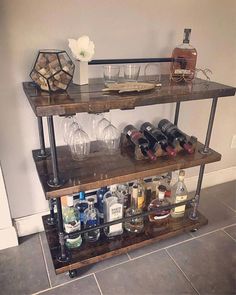 a shelf filled with bottles and glasses on top of a tiled floor