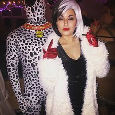 a woman dressed in costume standing next to a man wearing a dalmatian suit