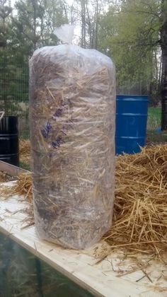 a large bag of hay sitting on top of a wooden table