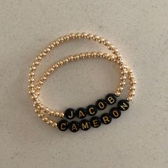 This listing is for 1 custom 14k gold filled 4mm beaded bracelet with black beads with gold letters. Each bracelet can be personalized with a name of your choice along with your desired length. Please leave a note in the comments section when you check out stating what letters you would like. Letter beads will all be placed together with gold beads on either side. These bracelets will not tarnish and look great alone or in a stack! Bracelets come in an organza pouch and make perfect gifts. I wil Personalized Yellow Gold Jewelry With Round Beads, Personalized Yellow Gold Beaded Bracelets With Round Beads, Personalized Yellow Gold Beaded Bracelets, Personalized Round Bead Gold Bracelets, Personalized Gold Name Bracelet With Round Beads, Personalized Gold Beaded Bracelets As Gift, Personalized Gold Beaded Bracelets For Gift, Elegant Gold Beaded Bracelet With Custom Name, Gold Beads Name Bracelet As Gift