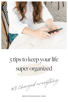 a woman sitting at a table with her cell phone in her hand and the words 5 tips to keep your life super organized