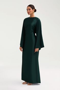 The Batool Dress is meant to have an oversized body design, complimented by an adjustable tie wrap. Size down if in between sizes. Indulge in luxury with the Batool Satin Maxi Dress. Its loose wide sleeves and lustrous satin fabric exude elegance, while the adjustable tie waist flatters your figure. Versatile design makes it perfect for Eid and beyond. Elevate your style with this exclusive piece. Model is 5'7 wearing size XS/58" Flowy Dress Hijab, Long Sleeves Formal Dress, Long Sleeve Maxi Satin Dress, Long Dresses With Long Sleeves, Black Dress Classy Plus Size, Modest Dress Wedding Guest, Satin Maxi Dresses, New Models Dresses, Long Sleeve Slip Dress