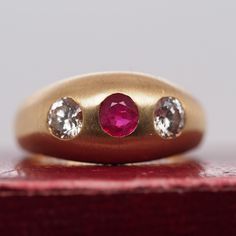 Item Details: Ring Size: 9.75 Metal Type: 14k White Gold [Hallmarked, and Tested] Weight: 9.6 grams Center Ruby Details: Red, Natural, .60ct, Round Diamond Details: .50ct each, K Color, VS Clarity, Transitional Round Band Width: 4.5mm Condition: Excellent Price: $2750 This ring can be sized up or down 4 sizes for an additional $40. If you wish to have a ring sized please purchase the item and note the size in the message section. Payment & Refund Details: More Pictures Available on Request Payment via Visa/Mastercard/Discover/AmericanExpress, check, money order or PayPal. Layaway * We will be more than happy to provide layaway payments for your convenience to make it easier to have the opportunity to enjoy one of our collection's treasure! Please contact us in advance so we can work out a Classic Domed Ruby Ring, Vintage Signet Ring With Brilliant Cut, Classic Yellow Gold Three Stone Ruby Ring, Classic Three Stone Ruby Ring In Yellow Gold, Classic Three Stone Yellow Gold Ruby Ring, Classic Three Stone Round Ruby Ring, Classic Yellow Gold Ruby Signet Ring, Vintage Brilliant Cut Signet Ring, Classic Three-stone Ruby Ring For Formal Occasions