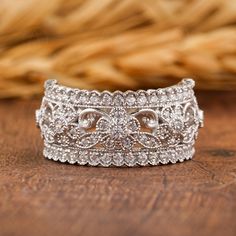 a diamond ring sitting on top of a wooden table