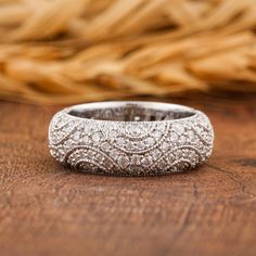 a diamond ring sitting on top of a wooden table