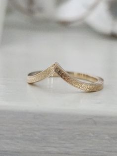 a gold ring sitting on top of a table