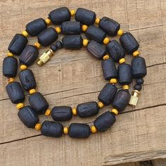 📿Necklace handcrafted with Black Shaded Tulsi Beads perfectely complimeted with rondelle Beige shaded tulsi beads. Tulsi Necklace is beneficial for people who have scattered minds and erratic behaviours, as it helps to keep the wearer focussed. 📿 🚪 NECKLACE DETAILS 🚪 📏Mala Beads size: 14 mm (Cylindrical) x 10 mm (Round) (Approx) 📏Mala Necklace Length: 19 inches 📏One Round 🚪 Pure Tulsi Beads Sourced from Vrindavan 📿 TULSI BEADS PROPERTIES 📿 🌹 Enormous physical healing powers 🌹 Rejuven Handmade Artisan Black Beaded Necklace, Black Round Beads Jewelry For Rituals, Handmade Artisan Black Beaded Necklaces, Handmade Black Artisan Beaded Necklaces, Artisan Black Handmade Beaded Necklace, Spiritual Single Strand Black Jewelry, Traditional Black Beaded Necklace For Gifts, Amber Necklace With Wooden Beads For Gifts, Black Amulet Necklace With Polished Beads