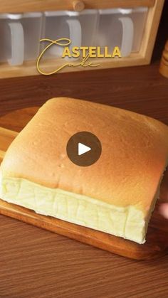 a wooden cutting board topped with cheese on top of a table